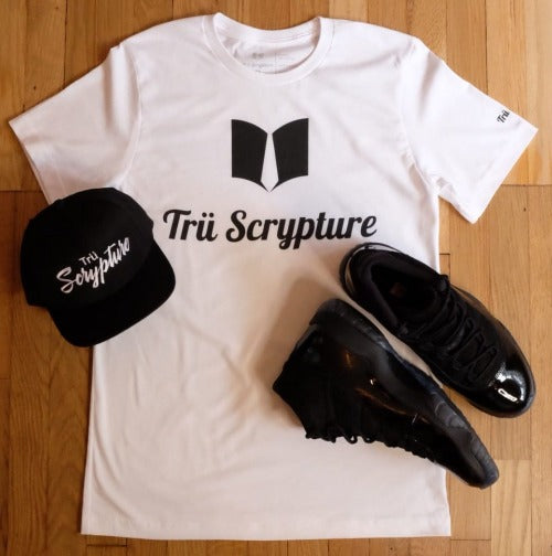 A picture of the T-Shirt which features the Fashion Book logo and the Trü Scrypture name which lays across the chest. This design also features the Trü Scrypture tag on the left sleeve. There is also an image of the Trü Scrypted Snapabck cap.
