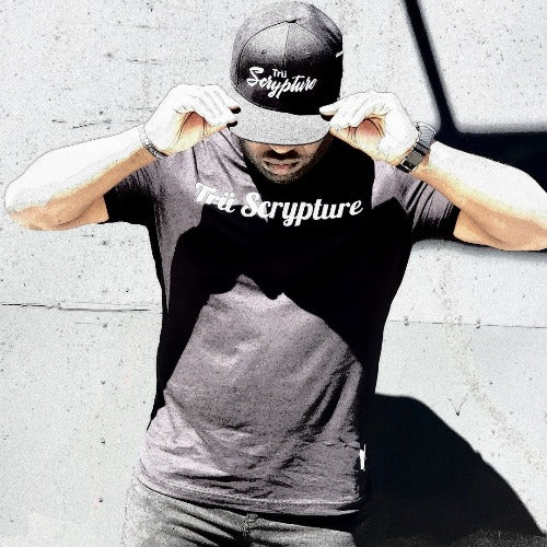 The model is wearing a black Trü Scrypture Signature Tee in an XL.