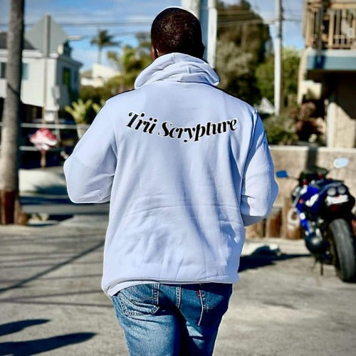 Model wearing the got trü hoodie in white from the back view.